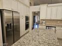 Well appointed kitchen with granite countertops, island, stainless appliances, and ample storage at 1635 W Wisteria Dr, Chandler, AZ 85248