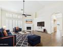 Spacious living room featuring a fireplace, vaulted ceiling, and an open floor plan at 1635 W Wisteria Dr, Chandler, AZ 85248