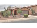 Charming single-story home with desert landscaping, enhancing curb appeal, and a two-car garage at 1814 N Parkside Ln, Casa Grande, AZ 85122