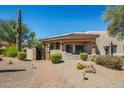 Southwestern home with a tile roof, desert landscaping, and a charming gated entrance at 24688 N 87Th St, Scottsdale, AZ 85255