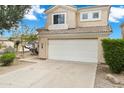 Inviting two-story home with a white garage door, desert landscaping, and a peaceful neighborhood setting at 30404 N 43Rd St, Cave Creek, AZ 85331