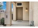 Welcoming front porch with a covered entry and a charming welcome mat, featuring textured walls and a stylish light fixture at 30404 N 43Rd St, Cave Creek, AZ 85331