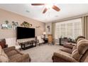 Inviting living room with ceiling fan, carpet flooring, and ample natural light at 3209 W Spur Dr, Phoenix, AZ 85083