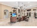 Cozy living room with tile flooring, a fireplace, and ample natural light at 3718 N Briere Ct, Buckeye, AZ 85396