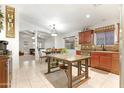 Open dining area with views into the living area and kitchen at 40142 W Coltin Way, Maricopa, AZ 85138