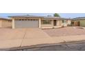 Well-maintained single-story home featuring a gray garage door and low-maintenance landscaping at 4126 E Carmel Ave, Mesa, AZ 85206