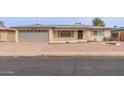 Inviting home exterior with a neutral color scheme, a two car garage, and desert landscaping at 4126 E Carmel Ave, Mesa, AZ 85206