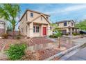 Inviting two-story home with a welcoming red door and well-kept landscaping at 4129 W Park St, Phoenix, AZ 85041