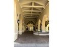 Covered entryway with arched openings, lanterns, tiled walls, and water features at 4200 N Miller Rd # 321, Scottsdale, AZ 85251