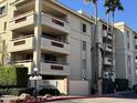 Exterior of a multi-story condominium building with balconies and manicured landscaping at 4200 N Miller Rd # 321, Scottsdale, AZ 85251