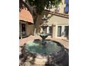 Outdoor water fountain on a brick surface of the luxury condominiums at 4200 N Miller Rd # 321, Scottsdale, AZ 85251