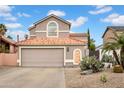 Charming two-story home features a red tile roof and desert landscaping, creating a welcoming curb appeal at 430 E Utopia Rd, Phoenix, AZ 85024