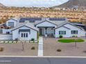 Elegant single-story home with pristine white exterior, solar panels and landscaped front yard at 6645 N Paint Ln, Casa Grande, AZ 85194