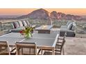 Inviting outdoor patio with plush seating, a modern fire pit, and a beautiful mountain view, perfect for entertaining at 7701 N Silvercrest Way, Paradise Valley, AZ 85253