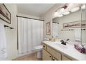 Clean bathroom with a shower-tub combo, light vanity, and decorative accents at 7755 E Laguna Azul Ave # 184, Mesa, AZ 85209