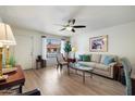 Cozy living room with a ceiling fan, neutral paint, and views of the front yard at 7755 E Laguna Azul Ave # 184, Mesa, AZ 85209