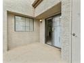 Private patio with a sliding glass door leading to the bright living room at 839 S Westwood -- # 273, Mesa, AZ 85210