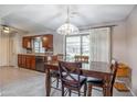 The dining room boasts wood floors and leads to the kitchen area through a sliding glass door at 9809 W Pleasant Valley Rd, Sun City, AZ 85351