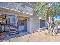 Condo exterior with private entrance, stairs, and landscaping, offering a welcoming facade at 10115 E Mountain View Rd # 1005, Scottsdale, AZ 85258
