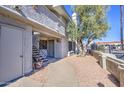 Condo exterior with private entrance, stairs, and landscaping, offering a welcoming facade at 10115 E Mountain View Rd # 1005, Scottsdale, AZ 85258