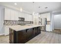 Stylish kitchen featuring a large island, stainless steel appliances, and decorative backsplash at 1372 N Zane Dr, Chandler, AZ 85226