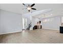 Spacious living area with stairs, a ceiling fan, and bar area with wine storage at 1372 N Zane Dr, Chandler, AZ 85226