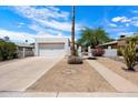 Inviting single-story home with a well-maintained front yard and two-car garage at 1510 E Wescott Dr, Phoenix, AZ 85024