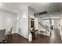 Inviting entryway with an adjacent dining room, stairway, and decorative furnishings at 1622 E Silverbirch Ave, Buckeye, AZ 85326