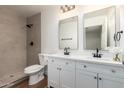 Well-lit bathroom featuring double vanities, modern fixtures, and a tiled shower at 1900 S Coconino Dr, Apache Junction, AZ 85120