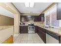 Modern kitchen features granite countertops, stainless steel appliances, and tile floors at 2348 W Laurel Ln, Phoenix, AZ 85029