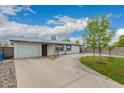 Well-maintained single-story home with a spacious concrete driveway, attached garage and grassy front yard at 4113 N 10Th Pl, Phoenix, AZ 85014