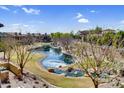 Scenic community view with a serene pond, mature trees, and beautiful landscaping at 4777 S Fulton Ranch Blvd # 2101, Chandler, AZ 85248