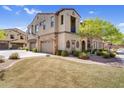 Well-maintained townhome featuring a two-car garage, lush lawn and manicured landscaping at 4777 S Fulton Ranch Blvd # 2101, Chandler, AZ 85248