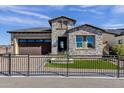 Charming single-Gathering home with stone accents, beautiful landscaping, and a dark brown garage at 5748 E Sierra Morena St, Mesa, AZ 85215