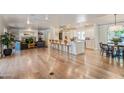 Open-concept living space with a modern kitchen, cozy seating area, fireplace, and hardwood floors at 5801 E Exeter Blvd, Phoenix, AZ 85018