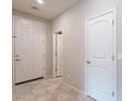 Bright entryway featuring tile floors, neutral paint, and a traditional design front door at 6853 E Posada Cir, Mesa, AZ 85212