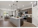 Modern kitchen featuring stainless steel appliances, a large island, and pendant lighting at 730 W Wind Cave Dr, San Tan Valley, AZ 85140
