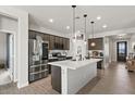 Bright kitchen showcasing stainless steel appliances and white countertops with stylish lighting at 730 W Wind Cave Dr, San Tan Valley, AZ 85140
