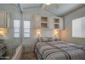 Bedroom featuring coordinated cabinets above a bed with natural lighting from the window at 7750 E Broadway Rd # 294, Mesa, AZ 85208