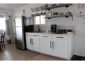 Cozy kitchen features stainless steel appliances, white cabinets, and floating shelves at 7807 E Main St # D-6, Mesa, AZ 85207