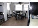 Eat-in kitchen with dining area, stainless appliances, and cozy lighting at 7807 E Main St # D-6, Mesa, AZ 85207