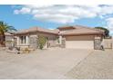 A beautifully landscaped desert yard with drought resistant plantings frames this attractive home and oversized driveway at 8004 W Robin Ln, Peoria, AZ 85383