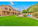 Expansive backyard featuring lush green grass and a refreshing pool, perfect for outdoor enjoyment at 9758 E Monterey Ave, Mesa, AZ 85209