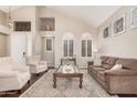 Bright living room featuring vaulted ceiling, natural light, and comfortable seating at 9758 E Monterey Ave, Mesa, AZ 85209
