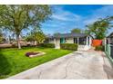 Attractive single-story home with a well-maintained lawn and mature trees on a sunny day at 1326 E Almeria Rd, Phoenix, AZ 85006