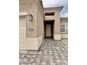 Inviting entryway features paver walkway, stucco walls, and stylish outdoor lighting at 15422 S Sequoia Cir, Arizona City, AZ 85123