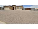 Charming single-story home with a two-car garage, gravel landscaping, and light tan stucco at 15422 S Sequoia Cir, Arizona City, AZ 85123