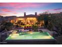 Backyard area featuring a large pool, spa, lounge chairs, and covered patio at 15956 E Tombstone Trl, Fountain Hills, AZ 85268