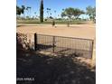 Wrought iron gate and block wall overlooking a pristine golf course at 1630 S Sossaman Rd, Mesa, AZ 85209