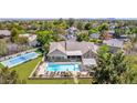 An aerial view showcases the back of the home featuring a pool, spa, covered patio and tennis court at 1632 S Alba Cir, Mesa, AZ 85204